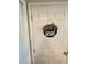 A white six panel door with a decorative sign that reads 