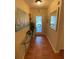 Elegant entryway featuring wood floors, glass console table, and a decorative mirror enhancing the space at 4504 Cabbage Palm Dr, Valrico, FL 33596