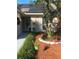 Charming front entrance with landscaped garden, decorative hanging plants and tasteful exterior design at 4504 Cabbage Palm Dr, Valrico, FL 33596