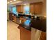 Updated kitchen with black countertops, stainless steel appliances and wood cabinetry at 4504 Cabbage Palm Dr, Valrico, FL 33596