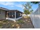 View of screened lanai and fenced backyard at 512 Red Mangrove Ln, Apollo Beach, FL 33572