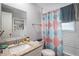 Bathroom features a granite countertop vanity, a toilet, and a shower with a patterned curtain at 512 Red Mangrove Ln, Apollo Beach, FL 33572