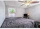 Bedroom with neutral walls, ceiling fan, wood-look floors, and natural light at 512 Red Mangrove Ln, Apollo Beach, FL 33572