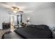 Bedroom with neutral walls, ceiling fan, wood-look floors, and an ensuite bathroom at 512 Red Mangrove Ln, Apollo Beach, FL 33572