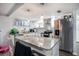 Bright kitchen features granite countertops, stainless steel appliances, and pendant lighting at 512 Red Mangrove Ln, Apollo Beach, FL 33572