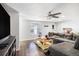 Comfortable living room with hardwood floors, ceiling fan, and ample space for relaxation at 512 Red Mangrove Ln, Apollo Beach, FL 33572