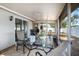 Enclosed patio featuring a glass table with seating, offering an ideal space for relaxation and outdoor dining at 512 Red Mangrove Ln, Apollo Beach, FL 33572