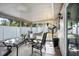 Enclosed patio featuring a glass table with seating, offering an ideal space for relaxation and outdoor dining at 512 Red Mangrove Ln, Apollo Beach, FL 33572