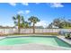 Backyard pool is surrounded by lush greenery and palm trees, creating a private oasis at 5519 Homewood Dr, Sarasota, FL 34232