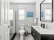 Bright bathroom featuring a glass shower with marble tile, modern vanity, and stylish black framed mirror at 5519 Homewood Dr, Sarasota, FL 34232