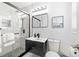 Bathroom with a tiled glass shower, sleek black vanity, and modern vanity mirror at 5519 Homewood Dr, Sarasota, FL 34232