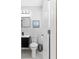 This bathroom features a modern vanity with white marble floors, toilet, and a framed sailboat decor at 5519 Homewood Dr, Sarasota, FL 34232