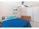 Comfortable bedroom with a queen bed, futon, ceiling fan, and ample closet space at 5519 Homewood Dr, Sarasota, FL 34232
