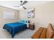 Inviting bedroom with a modern ceiling fan, comfortable queen bed, and cozy futon at 5519 Homewood Dr, Sarasota, FL 34232