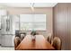 Dining area features a modern table with seating for six, with stainless steel refrigerator in view at 5519 Homewood Dr, Sarasota, FL 34232