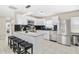 Updated kitchen with white cabinetry, granite countertops, stainless appliances, and an eat-in bar at 5519 Homewood Dr, Sarasota, FL 34232