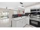 Bright, open kitchen with granite countertops and a stainless steel oven, seamlessly connected to the living area at 5519 Homewood Dr, Sarasota, FL 34232