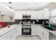 Modern kitchen featuring white cabinets, stainless steel appliances, and granite countertops at 5519 Homewood Dr, Sarasota, FL 34232