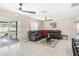 Open concept living room with a plush sectional sofa and sliding glass doors to the outdoor patio at 5519 Homewood Dr, Sarasota, FL 34232