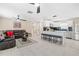 Open-concept living area showcasing a modern kitchen, a brown leather sofa, and bright neutral flooring at 5519 Homewood Dr, Sarasota, FL 34232