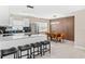 Open concept living space with modern kitchen, breakfast bar, dining area, and stainless steel appliances at 5519 Homewood Dr, Sarasota, FL 34232