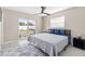 Bright main bedroom featuring a ceiling fan, a sliding glass door, and a comfortable bed at 5519 Homewood Dr, Sarasota, FL 34232