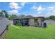 Landscaped backyard featuring a screened porch, well-maintained lawn, and garden at 5591 15Th N Ave, St Petersburg, FL 33710