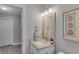 Updated bathroom boasts granite countertop, new light fixture and framed mirror at 5591 15Th N Ave, St Petersburg, FL 33710