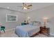Cozy bedroom features a ceiling fan, a desk, and two side tables at 5591 15Th N Ave, St Petersburg, FL 33710