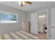 Well lit bedroom includes dresser and opens to a Primary bath at 5591 15Th N Ave, St Petersburg, FL 33710