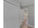 Hallway leading to an updated bathroom with tile floors and granite countertop at 5591 15Th N Ave, St Petersburg, FL 33710