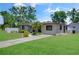 Charming single-story home with manicured front yard, landscaping, and inviting walkway at 5591 15Th N Ave, St Petersburg, FL 33710