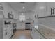 Updated kitchen featuring white cabinets, stainless steel appliances, granite counters, and a contemporary subway tile backsplash at 5591 15Th N Ave, St Petersburg, FL 33710