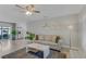 Cozy living room featuring a plush sofa, elegant lighting, and views into the adjoining kitchen and outdoor patio at 5591 15Th N Ave, St Petersburg, FL 33710