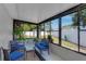 Enclosed sunroom features tile floor, multiple windows and comfortable seating at 5591 15Th N Ave, St Petersburg, FL 33710
