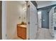 Charming half-bath boasts a vanity and a decorative wall mirror next to an entry glass block at 5864 Nature Terrace Cv, Tampa, FL 33617