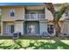 Townhome exterior showing a well-maintained lawn and back patio area with two AC units at 5864 Nature Terrace Cv, Tampa, FL 33617