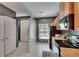 Functional kitchen with wood cabinets, black appliances, glass block, and tile flooring at 5864 Nature Terrace Cv, Tampa, FL 33617