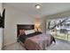 Main bedroom featuring cozy carpet and a sliding glass door with balcony access at 5864 Nature Terrace Cv, Tampa, FL 33617