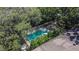 Aerial view of a community pool with lounge chairs and a surrounding fence at 5864 Nature Terrace Cv, Tampa, FL 33617