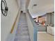 Staircase leads to the first story with a wood handrail and neutral-toned carpet steps at 5864 Nature Terrace Cv, Tampa, FL 33617