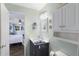 Neat bathroom with a marble vanity, decorative mirror, and view to the bedroom at 5980 Terrace Park N Dr # 214, St Petersburg, FL 33709