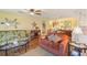 Inviting living room area decorated with sofas, lamps, tables, and a ceiling fan at 5980 Terrace Park N Dr # 214, St Petersburg, FL 33709