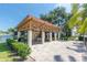 Outdoor pavilion with picnic tables and a grill, perfect for enjoying outdoor meals by the pond at 5980 Terrace Park N Dr # 214, St Petersburg, FL 33709