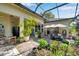 Back patio with a screen enclosure that offers ample gardening area at 6130 Japonica Ct, New Port Richey, FL 34655