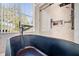 Elegant bathroom features a soaking tub next to the shower, with marble-style tile at 6130 Japonica Ct, New Port Richey, FL 34655