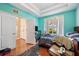 Bright bedroom featuring hardwood floors, a window, and a closet for ample storage at 6130 Japonica Ct, New Port Richey, FL 34655