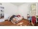 Cozy bedroom with wood-look floors and sunny window at 6130 Japonica Ct, New Port Richey, FL 34655