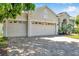Exterior of the home with three-car garage and paver driveway at 6130 Japonica Ct, New Port Richey, FL 34655