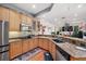 Open-concept kitchen with granite counters, stainless appliances, and ample cabinet space at 6130 Japonica Ct, New Port Richey, FL 34655